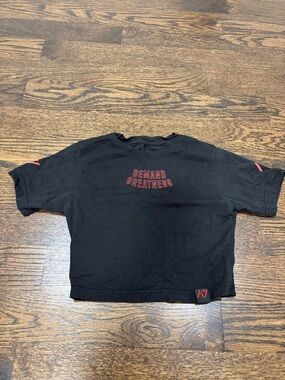 A7 Cropped Black "Demand Greatness" Comp Shirt